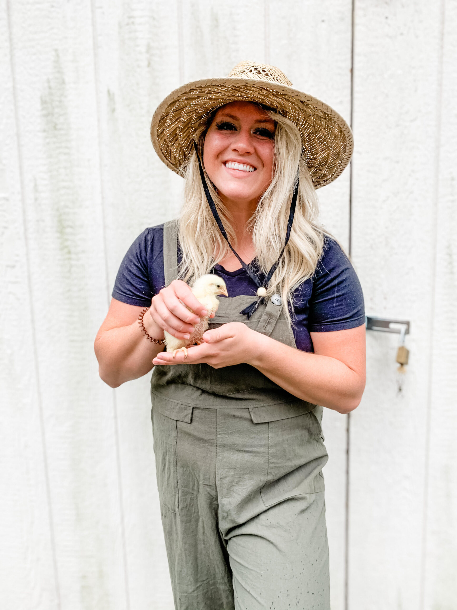 Holding a Cornish Broiler chick that we are raising. 