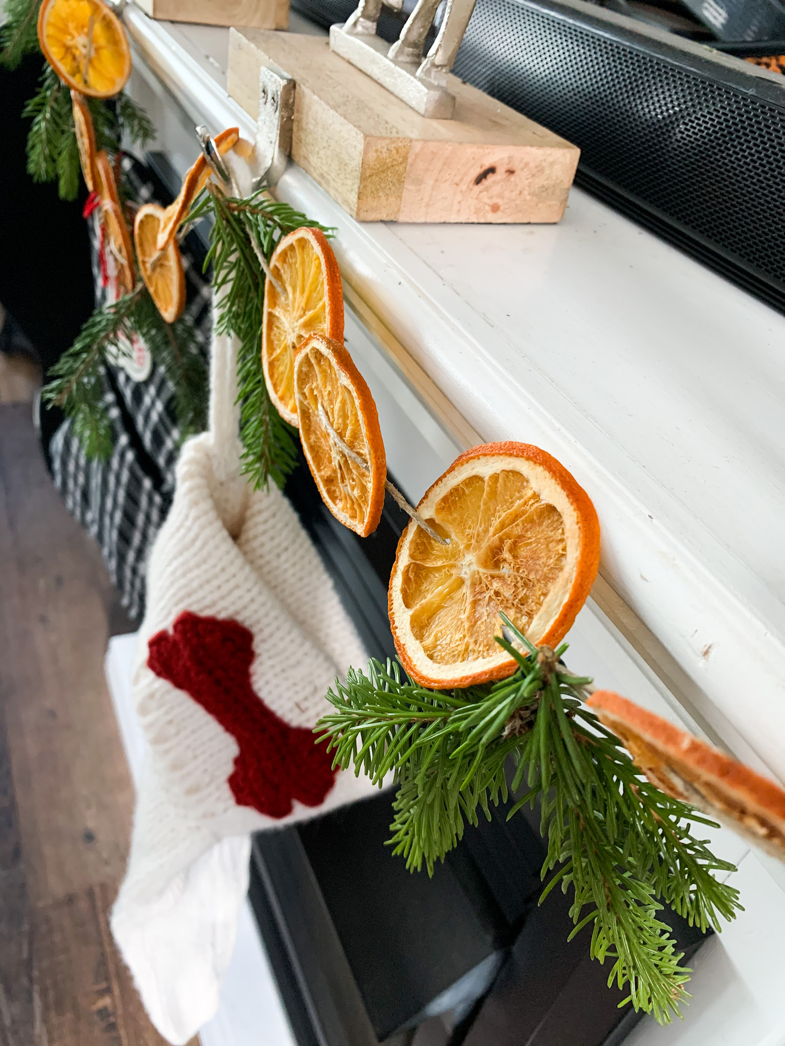 dried orange garland on the fireplace mantle with the stockings 