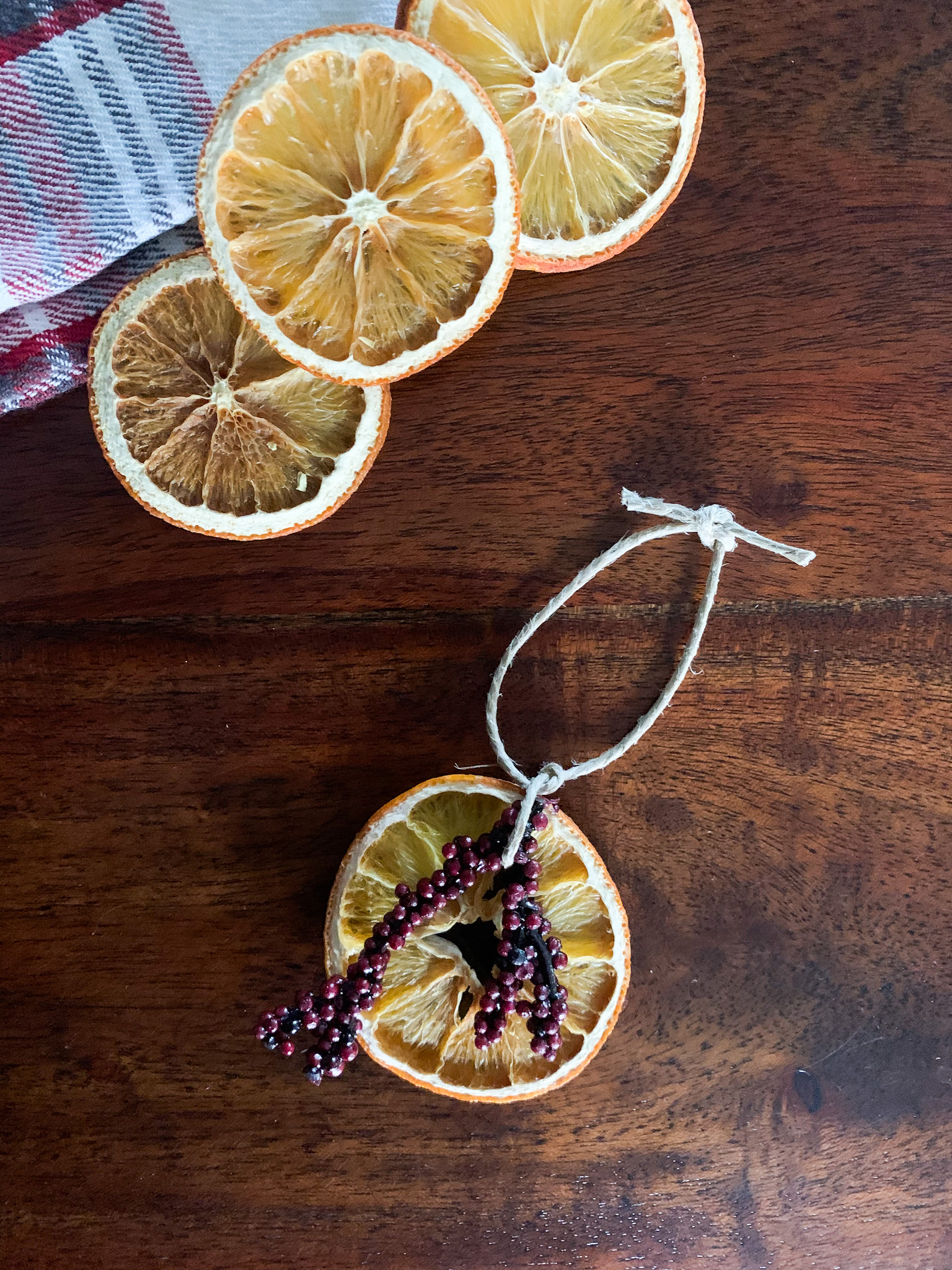 handmade dried orange ornament with floral and twine 