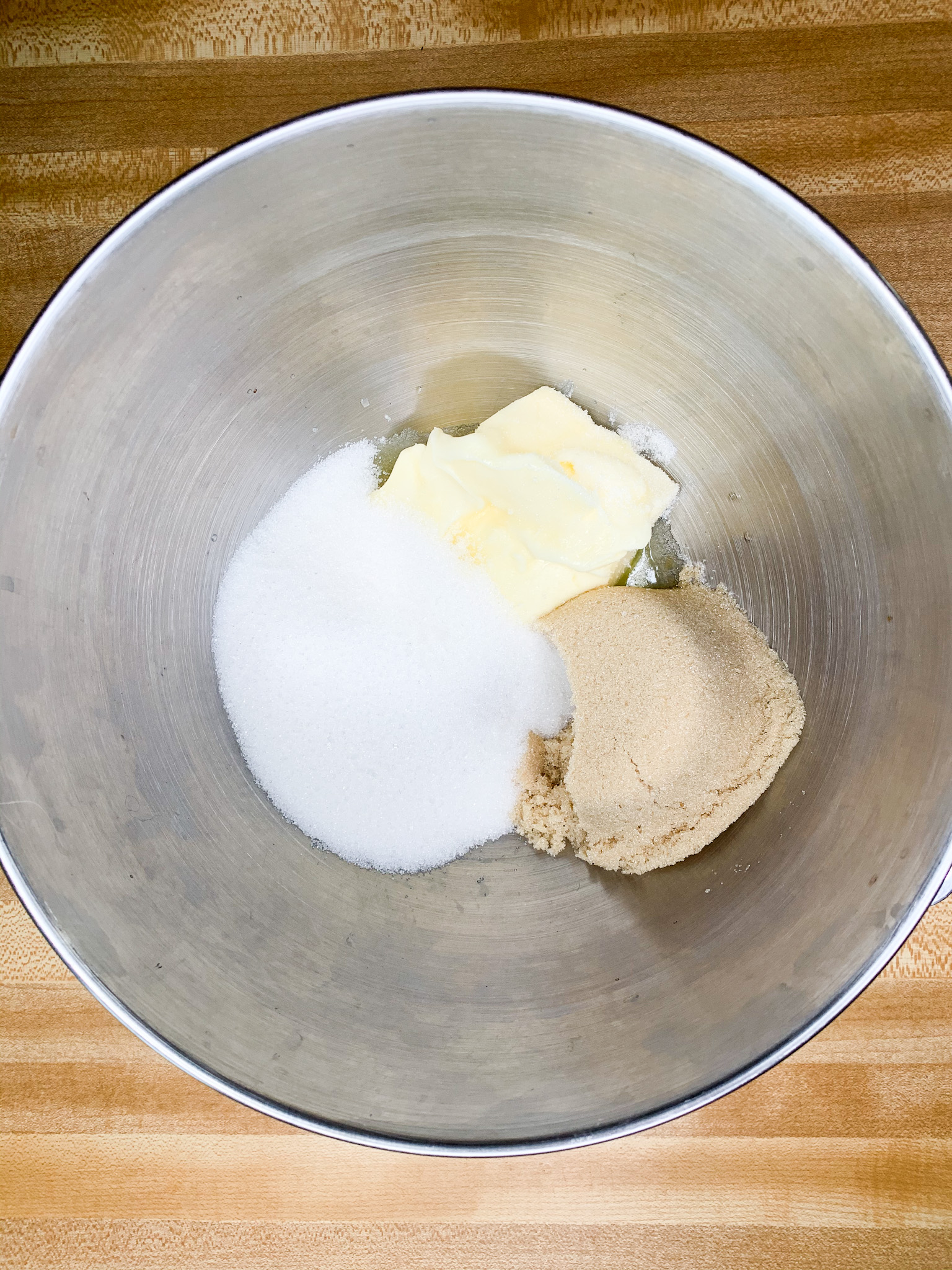 butter, white sugar, and brown sugar in a bowl