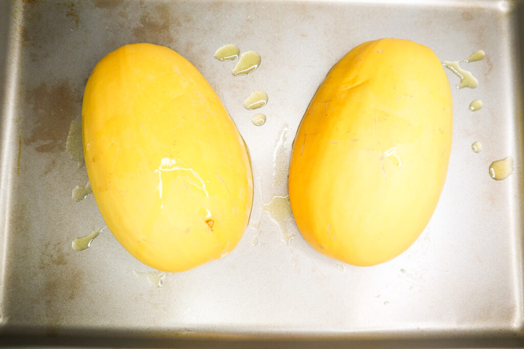 squash flipped over on a pan